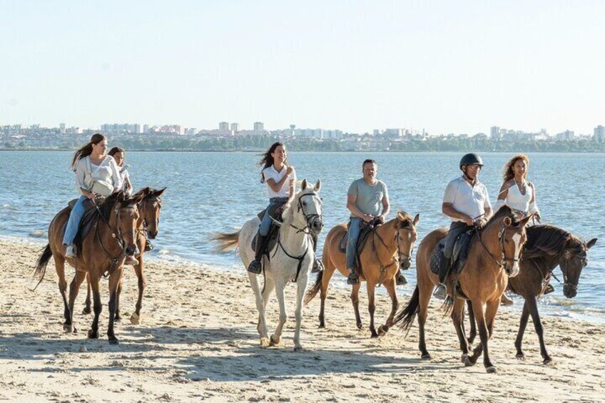 Horseback riding on the beach in group 
