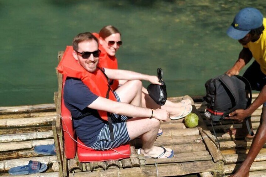 Couple relaxing on a bamboo raft 