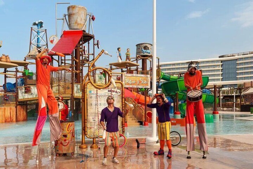 Vibrant street performers light up Meryal Waterpark with dazzling juggling, lively music, and impressive stilt walking.