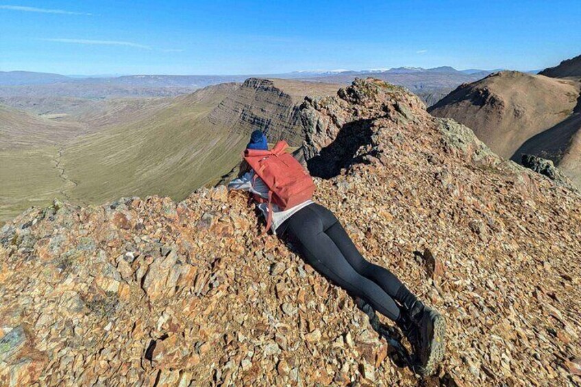 Hiker lying on the edge