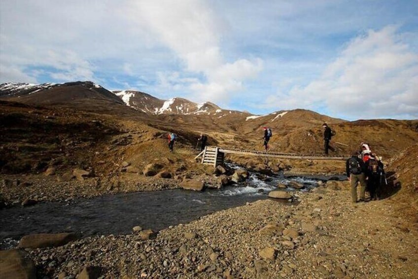 Hikers crossing a bridge
