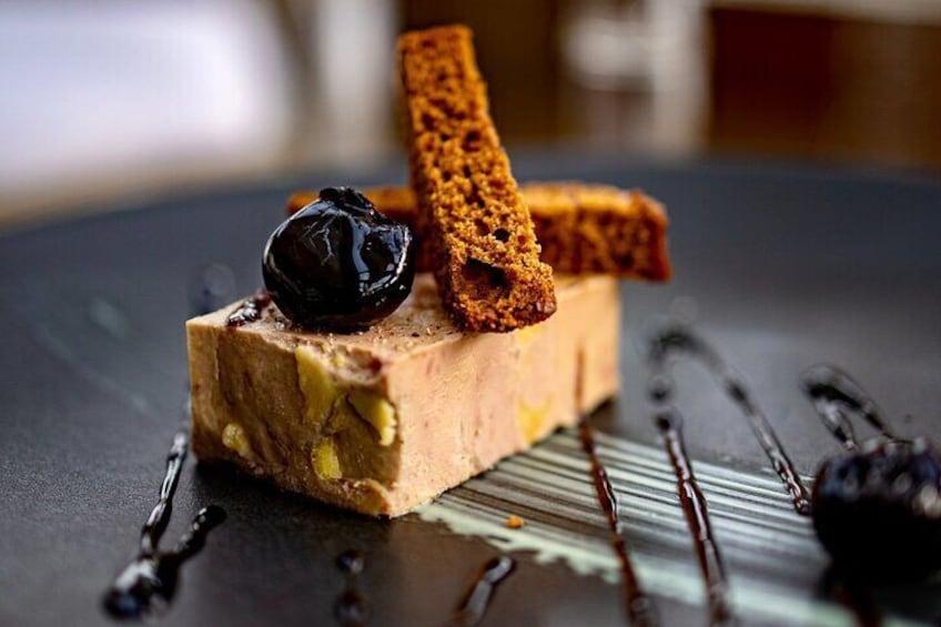 Foie gras cube with gingerbread chips and cherry caramel.