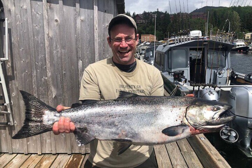 Captain Jack holds a client's king salmon.