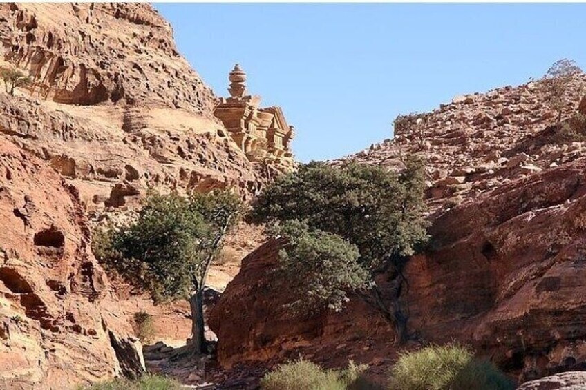 The trek to Petra from the northern route via Jabal ad-Deir, known as the Monastery, provides stunning views of the mountains and the vast plains of Wadi Araba.