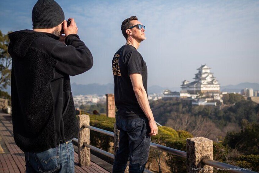 Guest snapping a shot on a Himeji photo walk with an Instax camera in hand.