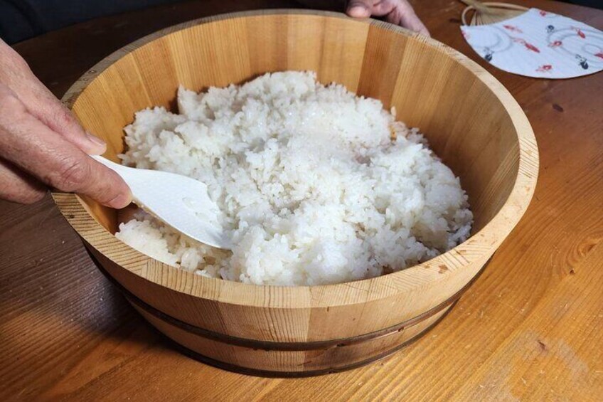 Sushi rice is made by mixing cooked rice with sushi vinegar.