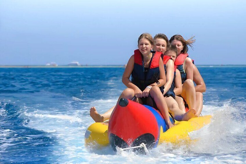 Family Enjoying a Banana Boat Ride During Their Trip to Dolphin House in Hurghada