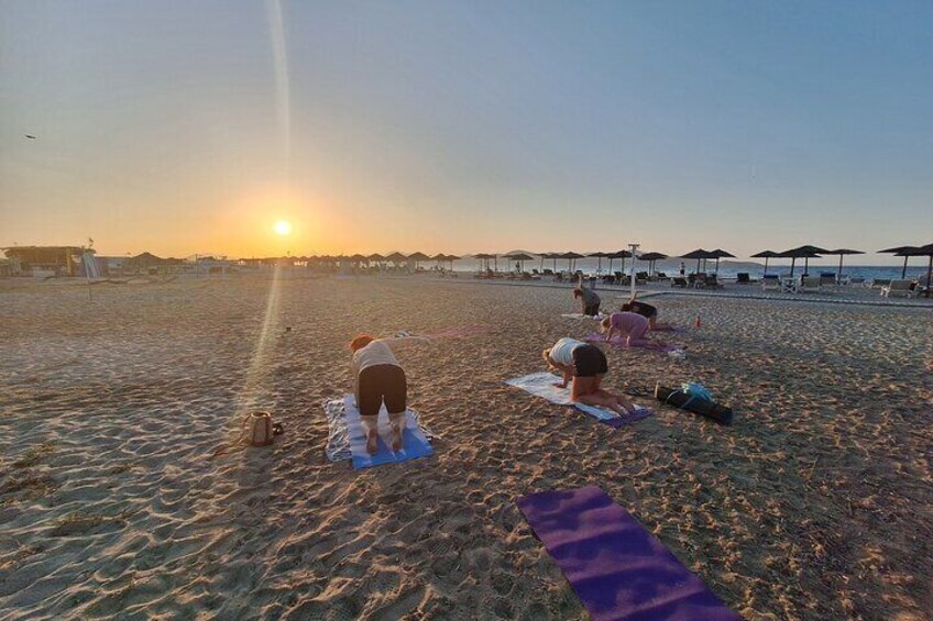 A group doing sunset Pilates on Tigaki Beach in Kos