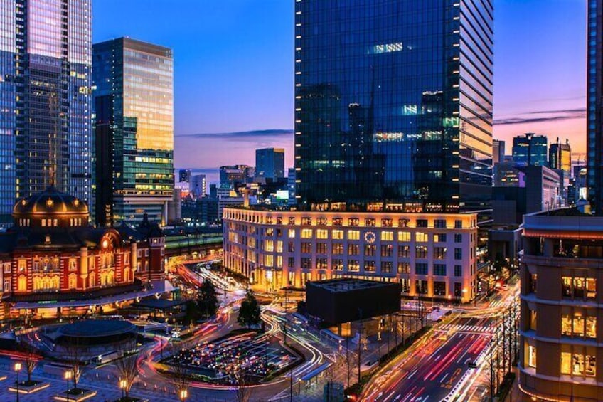 Tokyo Station's night view blends modern skyscrapers with traditional architecture, creating a stunning contrast