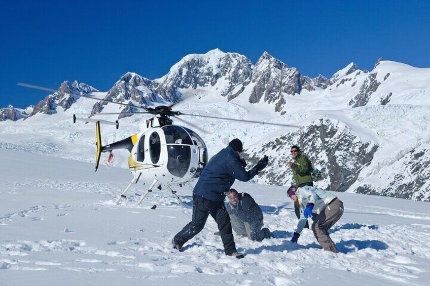 Snow landing on Chancellor Shelf, Fox Glacier. Mt Tasman in view and Mt Cook