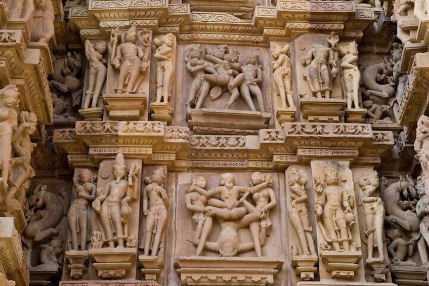 Stone carved erotic bas-relief in Hindu temple in Khajuraho, India. Unesco World Heritage Site.