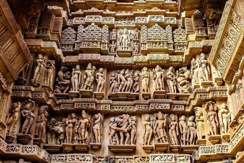 Close up of artful carved walls of Kandariya Mahadeva Temple, Khajuraho Group of Monuments, India.