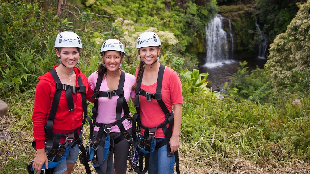 Group of ladies standing in front of a waterfall on the skyline Akaka Falls zipline tour on the Honomu Coast