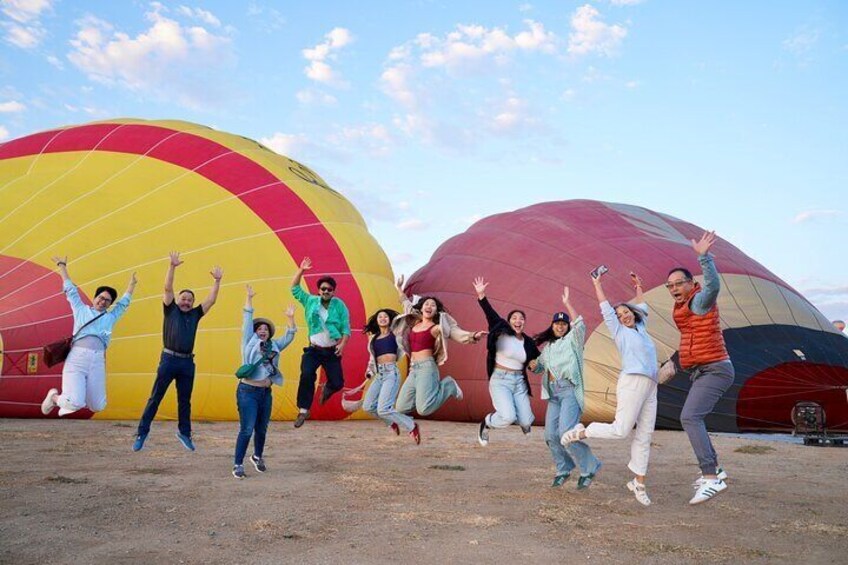 Jumping for joy over their hot air balloon flight