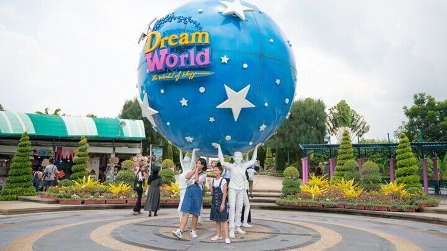 Tourist take photo The large Dream World logo globe.Dream World is one of Thailand's famous theme parks in Pathumtanee ,Thailand
