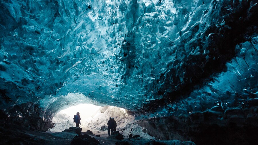 Group exploring an ice cave in Iceland