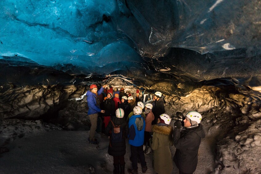 Group exploring an ice cave in Iceland