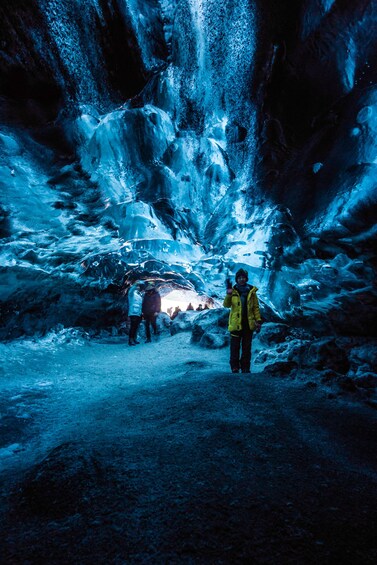 Group exploring an ice cave in Iceland