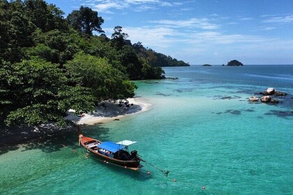 Snorkeling B Far way with longtail boat