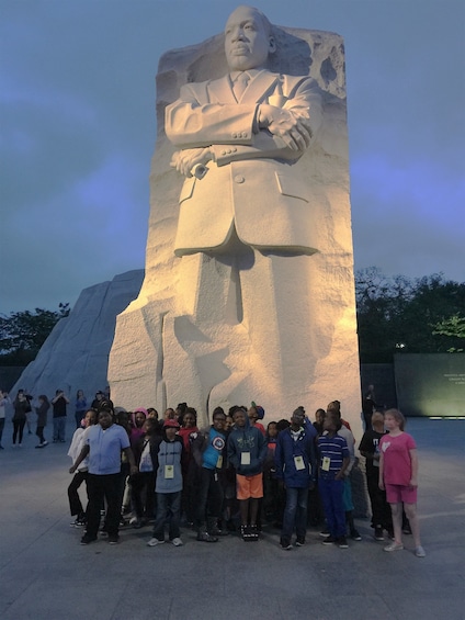 Show item 1 of 6. Group of people pose with a large statue of Martin Luther King Jr. in Washington D.C.