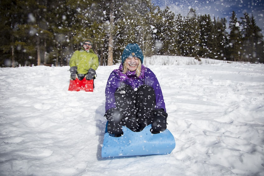 Couple sledding in Banff