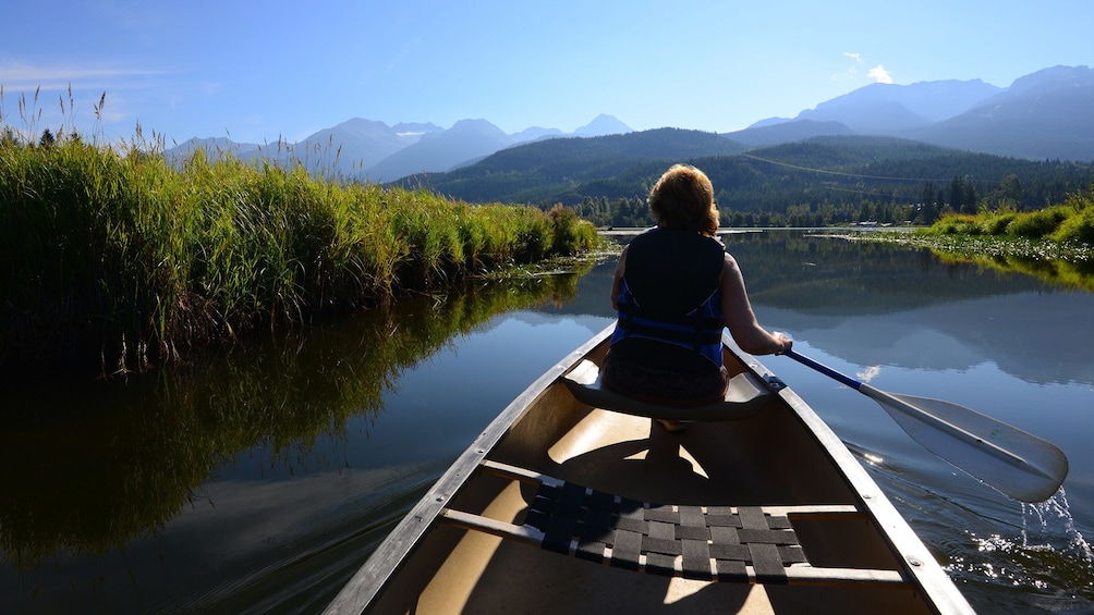 Woman in a canoe on a lake in Whistler