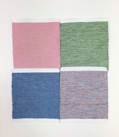 Four patches of pink, green, blue and purple fabric