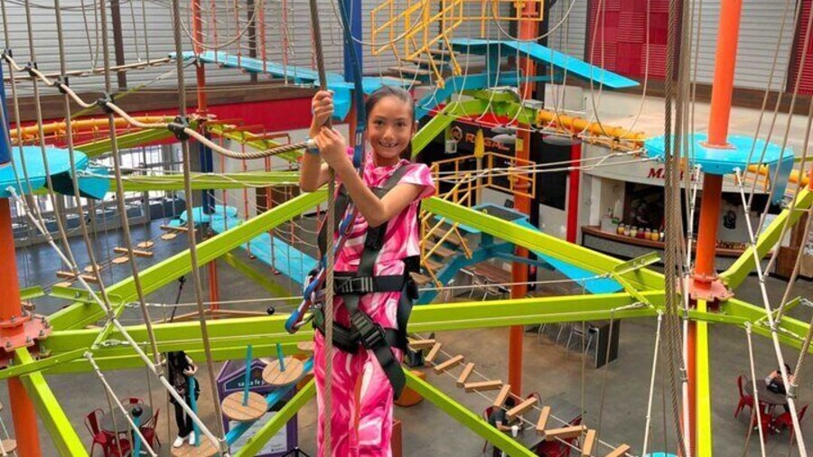 Smiling girl on the high ropes course