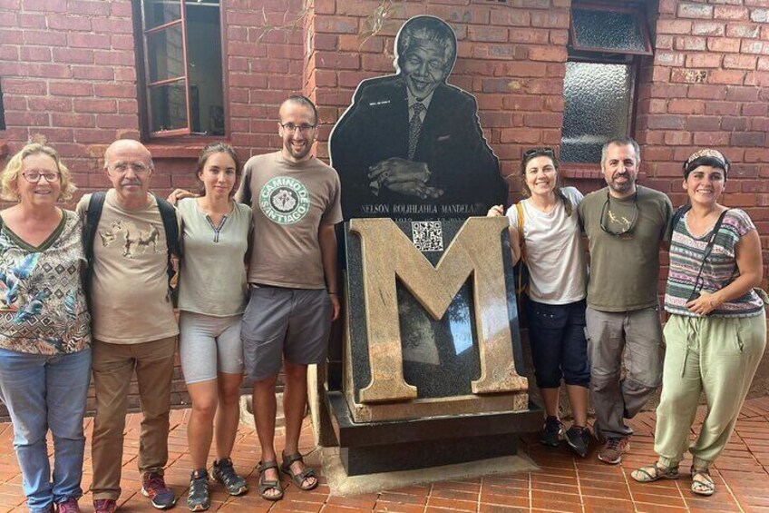 Clients with Nelson Mandela statute in Nelson Mandela house in Soweto