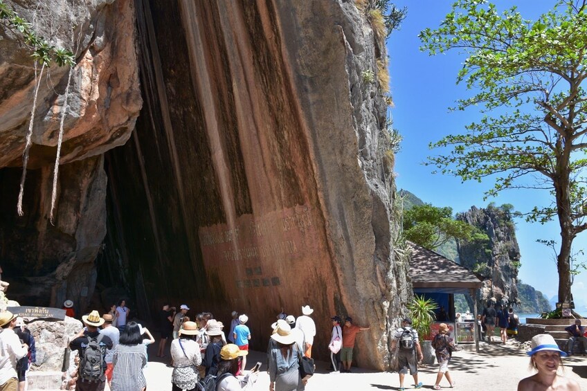 Group at mouth of a large cave in Thailand