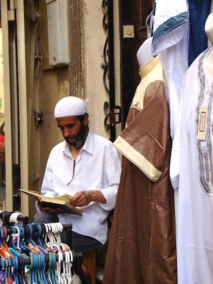 Shop owner reads book in Tangier, Morocco