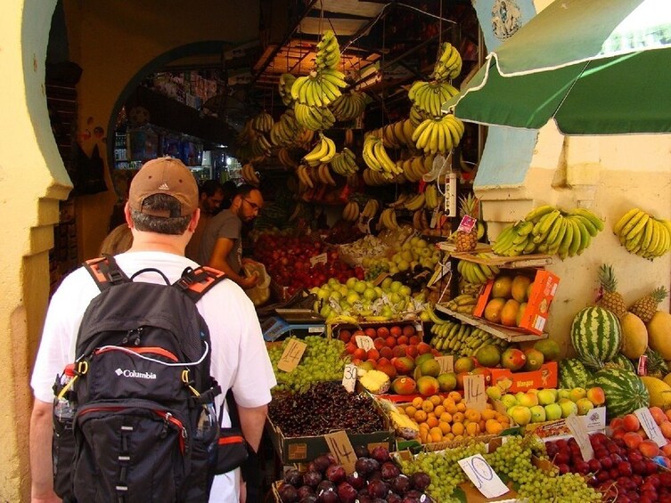Tourists at fruit stalls in Tangier, Morocco