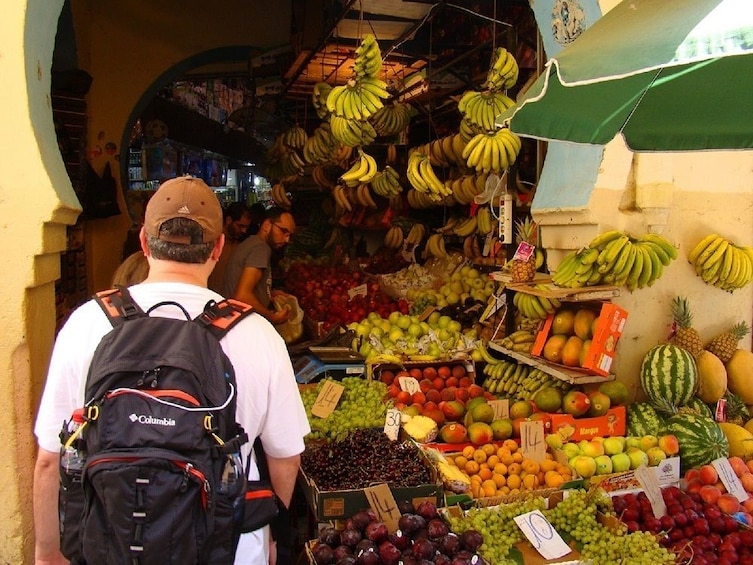 Tourists at fruit stalls in Tangier, Morocco