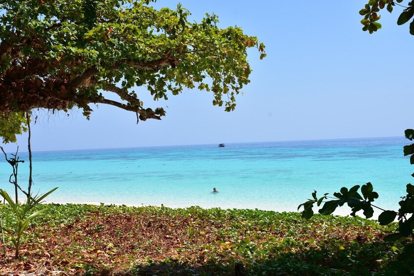 Man swimming off the coast of an island in Thailand