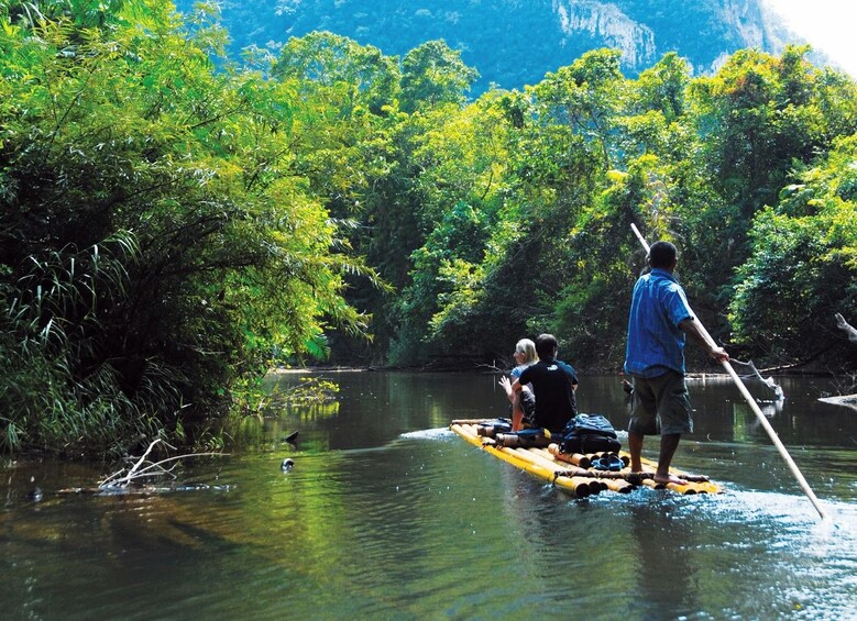 Couple on a bamboo raft on a river in Khao Sok National Park in Thailand