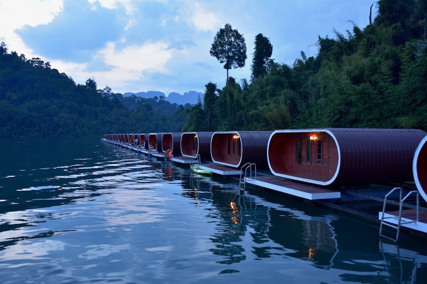 Floating cabins on Cheow Lan Lake at dusk in Thailand