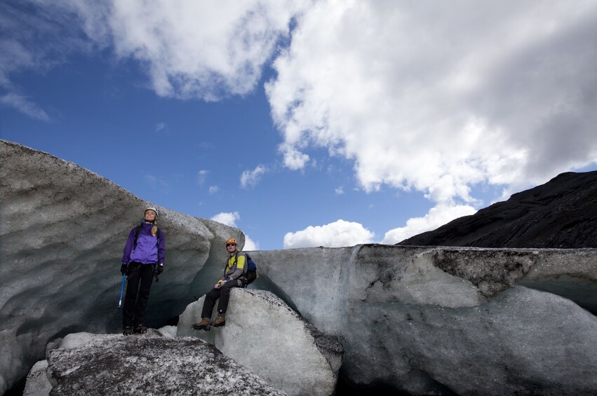 Couple climb glacier in Iceland