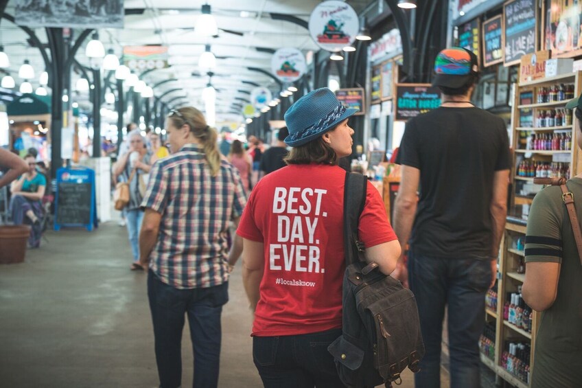 Tour group walking through a market in New Orleans