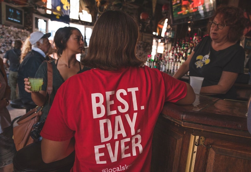 Show item 4 of 10. Tour guide with group at a bar in New Orleans