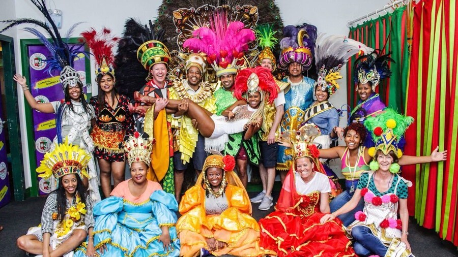 Tourists pose together in colorful Carnaval costumes