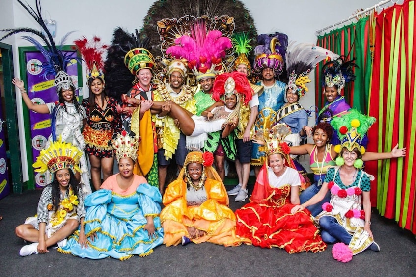 Tourists pose together in colorful Carnaval costumes
