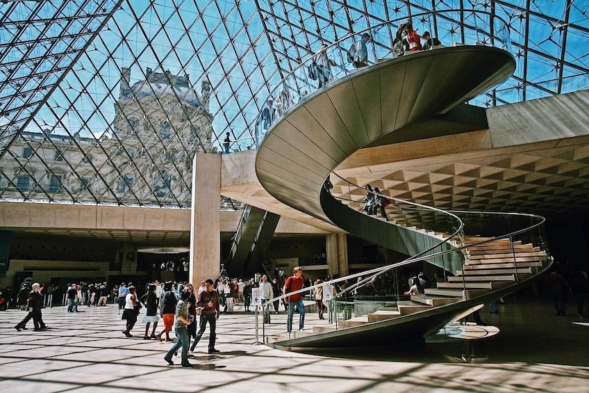 Spiral staircase under the glass pyramid at the Louvre Museum in Paris
