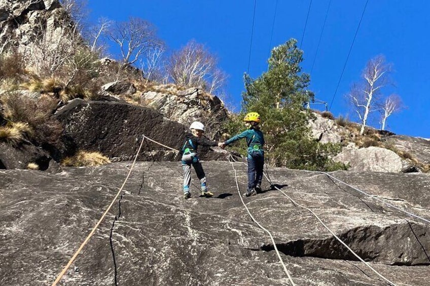 Family rock climbing near Locarno