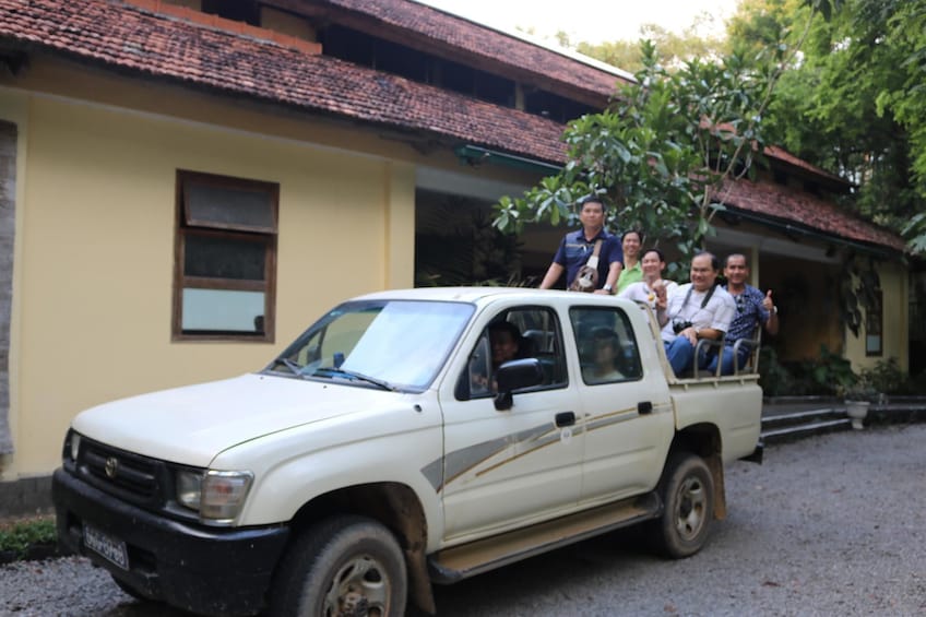 Tour group sitting on the back of a truck in Vietnam 