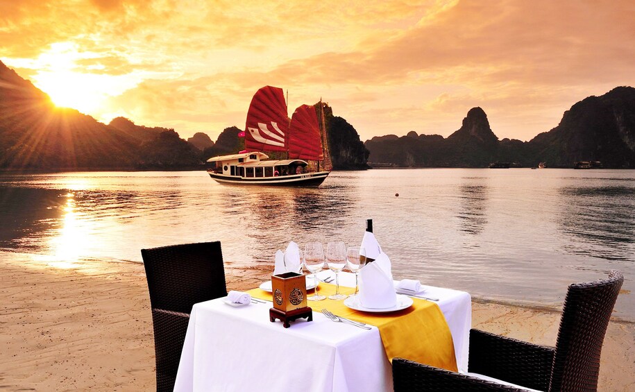 Table for two set on beach off Halong Bay