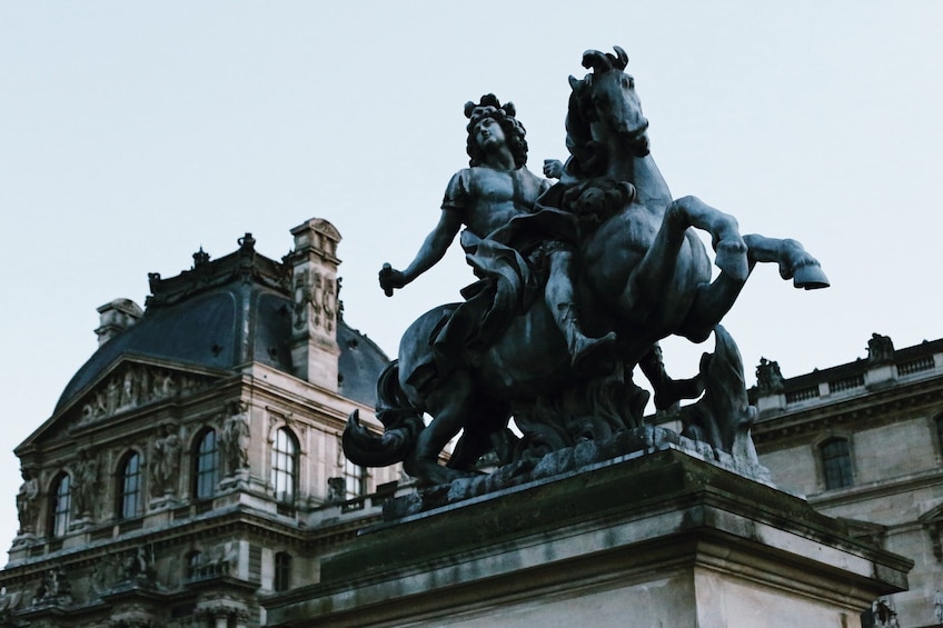 Statue of king Louis XIV in the courtyard of the Louvre museum 