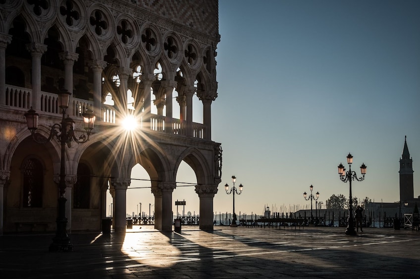 The sun sets through the Exterior of the Doge's Palace