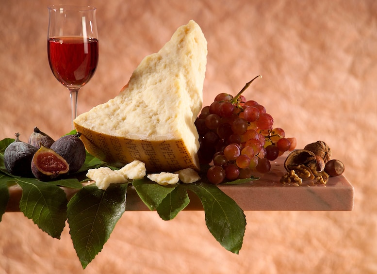 Show item 4 of 6. Wine, cheese, and grapes arranged artistically