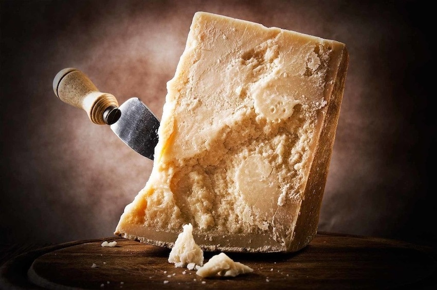 Show item 3 of 6. Knife in a block of Parmesan