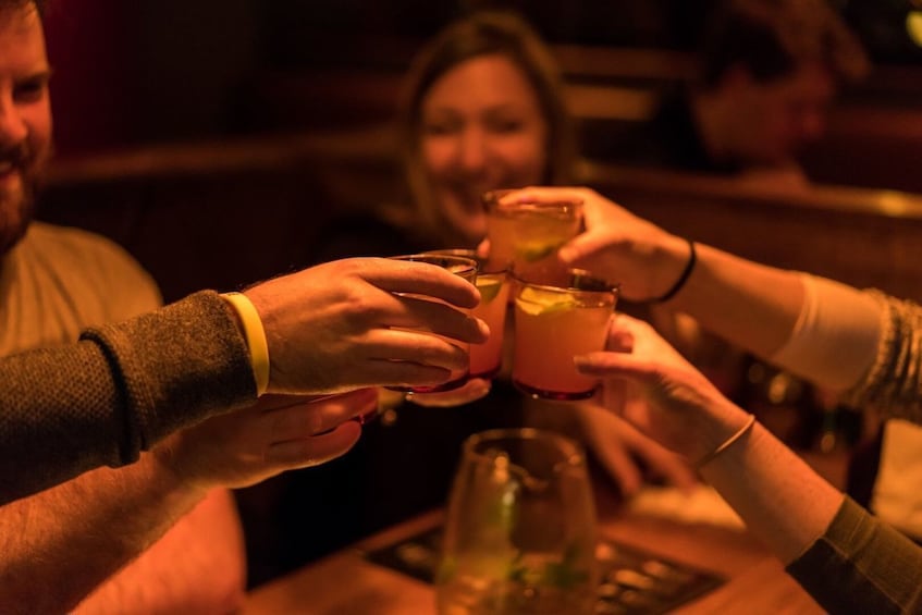 Group toasting cocktails at a bar in Melbourne